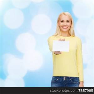 happiness and people concept - smiling young woman in casual clothes with white blank business or name card