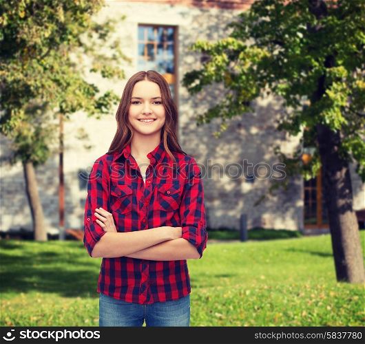 happiness and people concept - smiling young woman in casual clothes with crossed arms