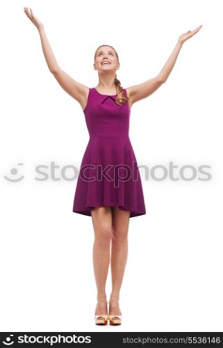 happiness and people concept - smiling young woman in dress waving hands