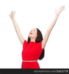 happiness and people concept - smiling young woman in red dress waving hands with closed eyes