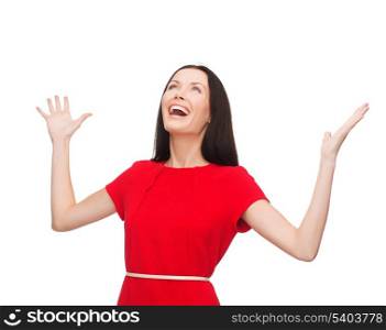 happiness and people concept - smiling young woman in red dress with hands up
