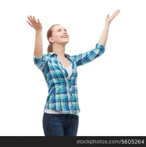 happiness and people concept - smiling young woman looking up with raised hands