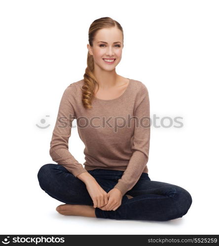 happiness and people concept - smiling young woman sitting on floor
