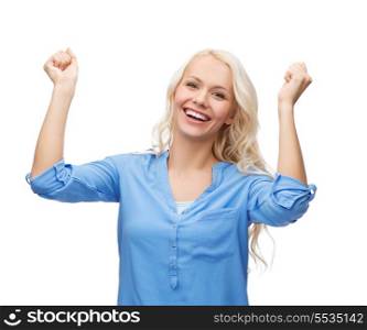 happiness and people concept - smiling young woman with hands up