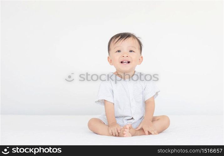 Happiness and smiling baby boy laughing on bed, kids playing concept