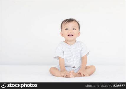 Happiness and smiling baby boy laughing on bed, kids playing concept