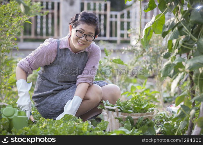 happiness asian woman relaxing in home vegetable gardening
