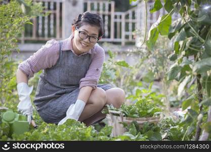 happiness asian woman relaxing in home vegetable gardening