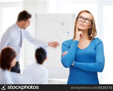 happiness, business, office and people concept - happy smiling young woman in black eyeglasses dreaming