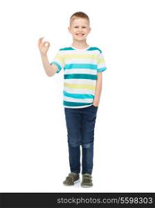 happiness, childhood, accomplishment and people concept - smiling little boy in casual clothes showing OK gesture
