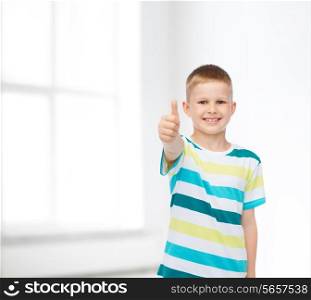 happiness, childhood and people concept - smiling little boy in casual clothes with crossed arms over white room background