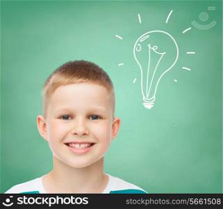 happiness, childhood and people concept - smiling little boy over green board background with bubble doodle