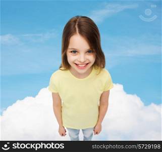 happiness, childhood and people concept - smiling little girl in blank t-shirt over blue sky and cloud background