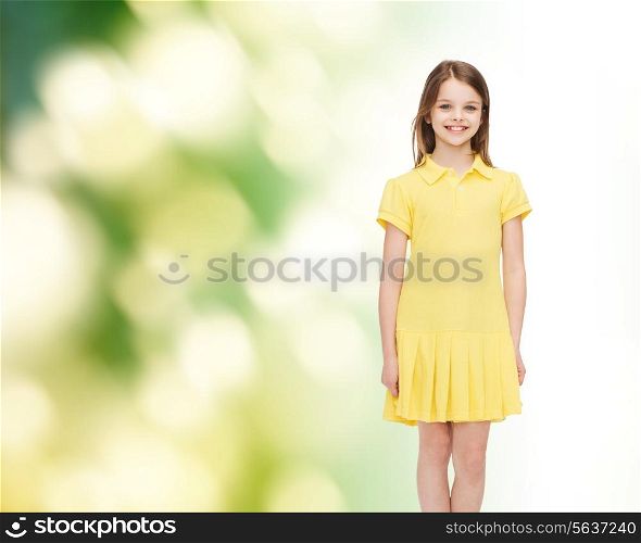 happiness, childhood and people concept - smiling little girl in yellow dress