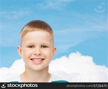 happiness, childhood, dreams and people concept - smiling little boy over blue cloudy sky background