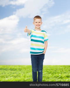 happiness, childhood, environment and people concept - smiling little boy in casual clothes showing thumbs up over natural background