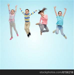 happiness, childhood, freedom, movement and people concept - happy little children jumping in air over blue background