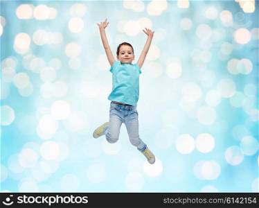 happiness, childhood, freedom, movement and people concept - happy little girl jumping in air over blue holidays lights background