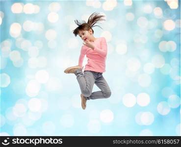happiness, childhood, freedom, movement and people concept - happy little girl jumping in air over blue holidays lights background