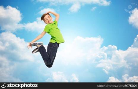 happiness, childhood, freedom, movement and people concept - smiling boy jumping in air over blue sky and clouds background