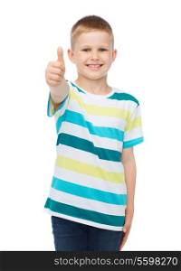 happiness, childhood, gesture and people concept - smiling little boy in casual clothes showing thumbs up