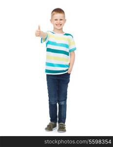 happiness, childhood, gesture and people concept - smiling little boy in casual clothes showing thumbs up