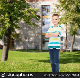 happiness, childhood, leisure and people concept - smiling little boy in casual clothes over campus background