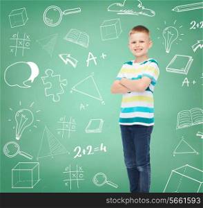 happiness, childhood, school, education and people concept - smiling little boy in casual clothes over green board with doodles background