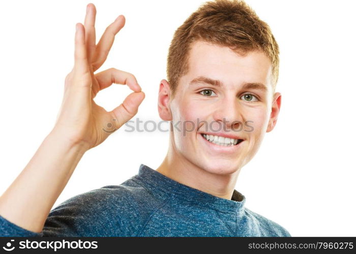 Happiness concept. Happy young man showing ok hand sign gesture isolated on white background