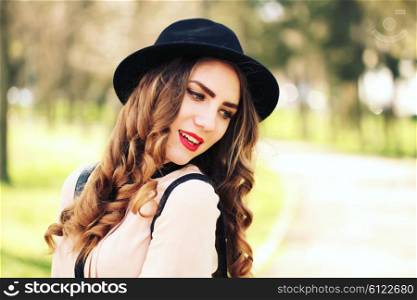 Happiness, consumerism, fashion and people concept - smiling young trendy hipster girl on city background in the sunlight outdoor