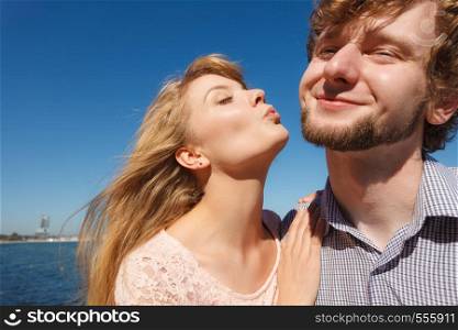 Happiness dating concept. Couple in love blonde woman handsome bearded man enjoy romantic date kissing, outdoor wide angle view. Dating. Couple in love kissing