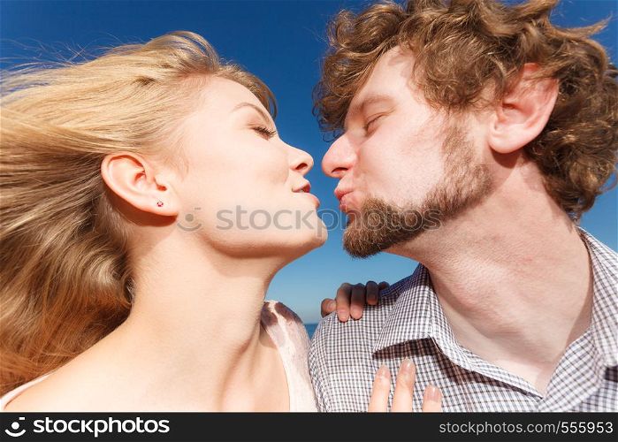 Happiness dating concept. Couple in love blonde woman handsome bearded man enjoy romantic date kissing, outdoor wide angle view. Dating. Couple in love kissing