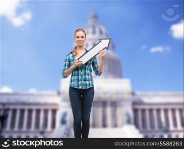 happiness, direction and people concept - smiling young woman arrow poiting up