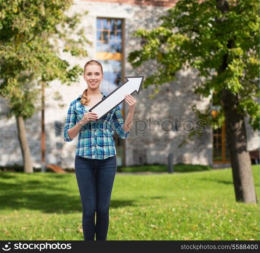 happiness, direction and people concept - smiling young woman arrow poiting up
