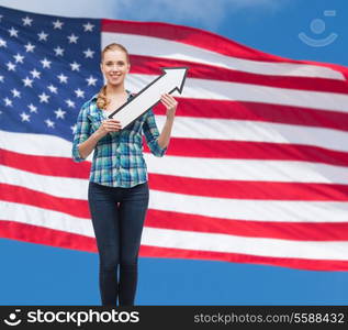 happiness, direction and people concept - smiling young woman arrow poiting up