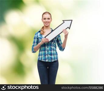 happiness, direction and people concept - smiling young woman arrow poiting up over green background