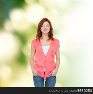 happiness, ecology and people concept - smiling teenage girl in casual clothes over green background