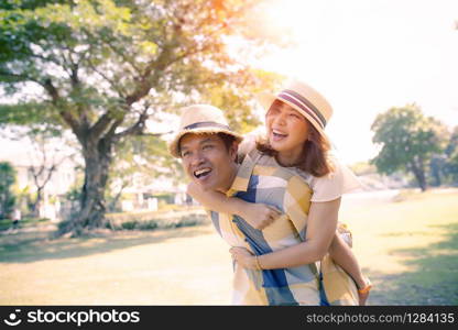 happiness emotion of asian man and woman toothy smiling face relaxing in public park