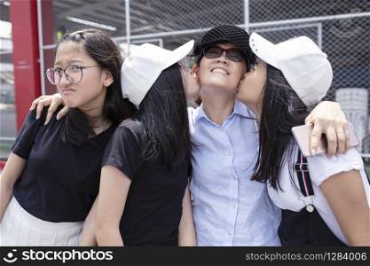 happiness emotion of asian teenger kissing on happiness face of woman