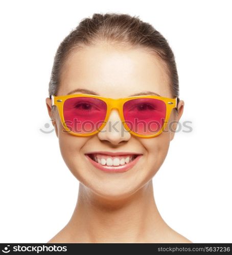 happiness, face expressions and people concept - portrait of smiling teenage girl in pink sunglasses