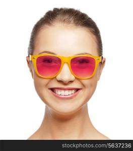 happiness, face expressions and people concept - portrait of smiling teenage girl in pink sunglasses