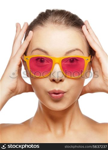 happiness, face expressions and people concept - portrait of surprised teenage girl in pink sunglasses