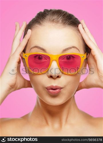 happiness, face expressions and people concept - portrait of surprised teenage girl in pink sunglasses