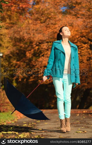 Happiness freedom and people concept. Casual young woman teen girl walking relaxing with blue umbrella in autumnal park, outdoor