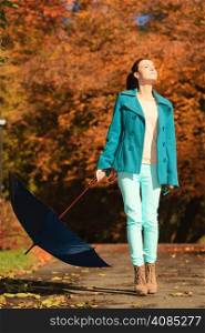 Happiness freedom and people concept. Casual young woman teen girl walking relaxing with blue umbrella in autumnal park, outdoor