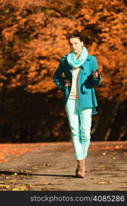 Happiness freedom and people concept. Casual young woman teen girl walking relaxing with umbrella in autumnal park, outdoor