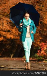 Happiness freedom and people concept. Casual young woman teen girl walking relaxing with blue umbrella in autumnal park, outdoor