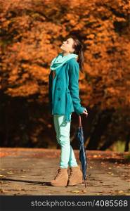 Happiness freedom and people concept. Casual young woman teen girl walking relaxing with umbrella in autumnal park, outdoor