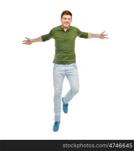 happiness, freedom, motion and people concept - smiling young man jumping in air