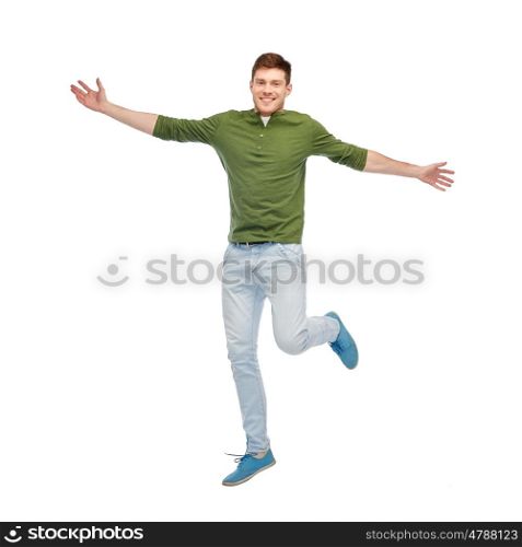happiness, freedom, motion and people concept - smiling young man jumping in air
